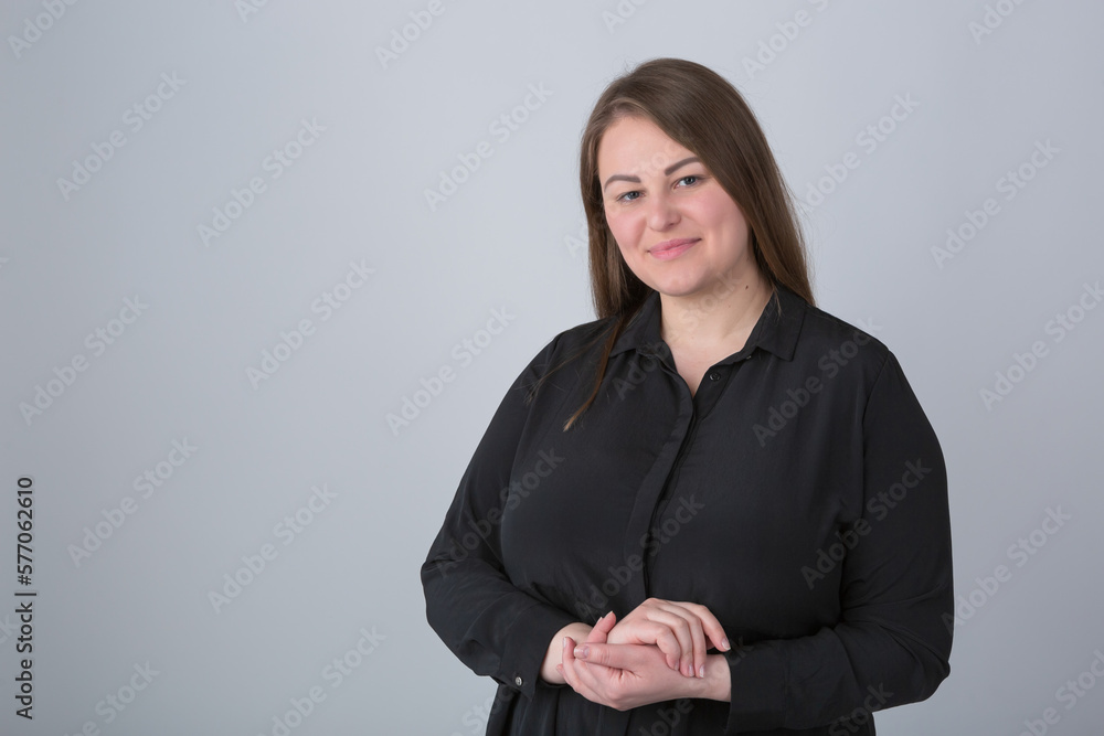Cheerful plus size woman in casual black shirt posing in the studio. Portrait of friendly white overweight female Cheerful plus size woman in casual black shirt posing in the studio. Portrait of friendly white overweight female