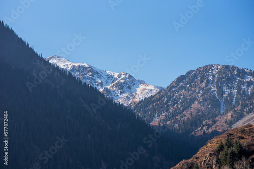 Panorama of a mountain landscape in northern China with snow-capped mountains. Foggy autumn day with first snow in Qitai county Xinjiang Uygur Autonomous Region, China.