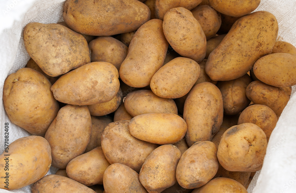 Fresh potatoes in a package. Top view. Vegetable background Fresh potatoes in a package. Top view. Vegetable background