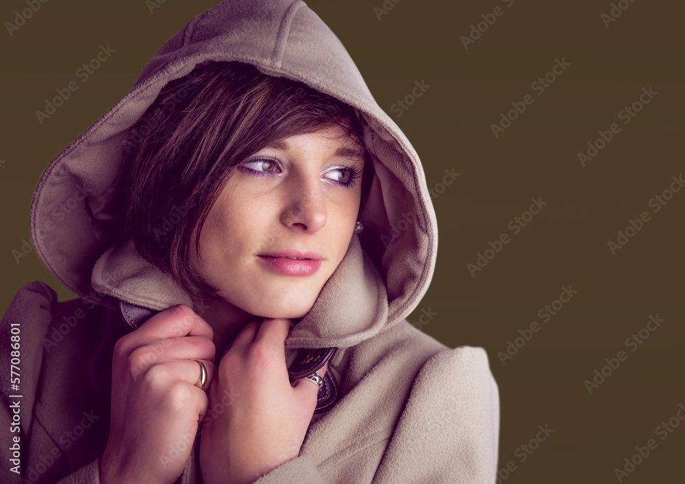 Caucasian woman wearing a hoodie against copy space on brown background Caucasian woman wearing a hoodie against copy space on brown background