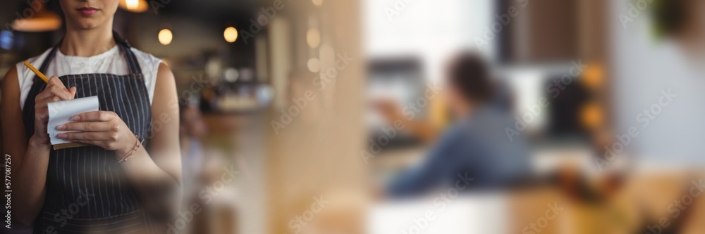Blurred effect with copy space against mid section of a waitress taking an order at a restaurant Blurred effect with copy space against mid section of a waitress taking an order at a restaurant