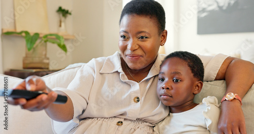 Love, mother and girl streaming a movie while relaxing on a sofa in the modern living room. Happy, smile and black family watching a film online in lounge while bonding, talking and resting together