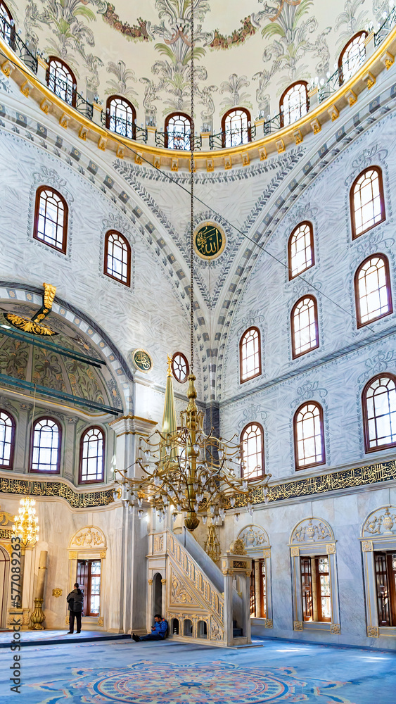 Istanbul, Turkey - April 20, 2022. Interior of prayer hall in the Nuruosmaniye Mosque, Istanbul, Turkey. Ottoman baroque style. Arabic text as decor (verses from Koran, muslim Holy book)