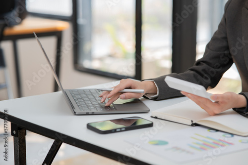 Businesswoman hand using laptop sitting at office