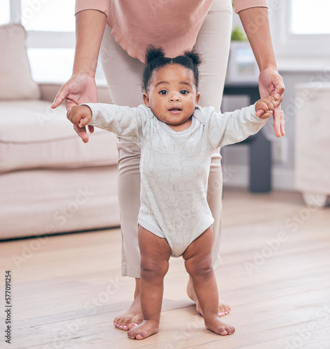 Black baby portrait, walking and learning with mother in a living room lounge with mobility development. Floor, home and first steps of a young kid with mama help with love, care and support in house