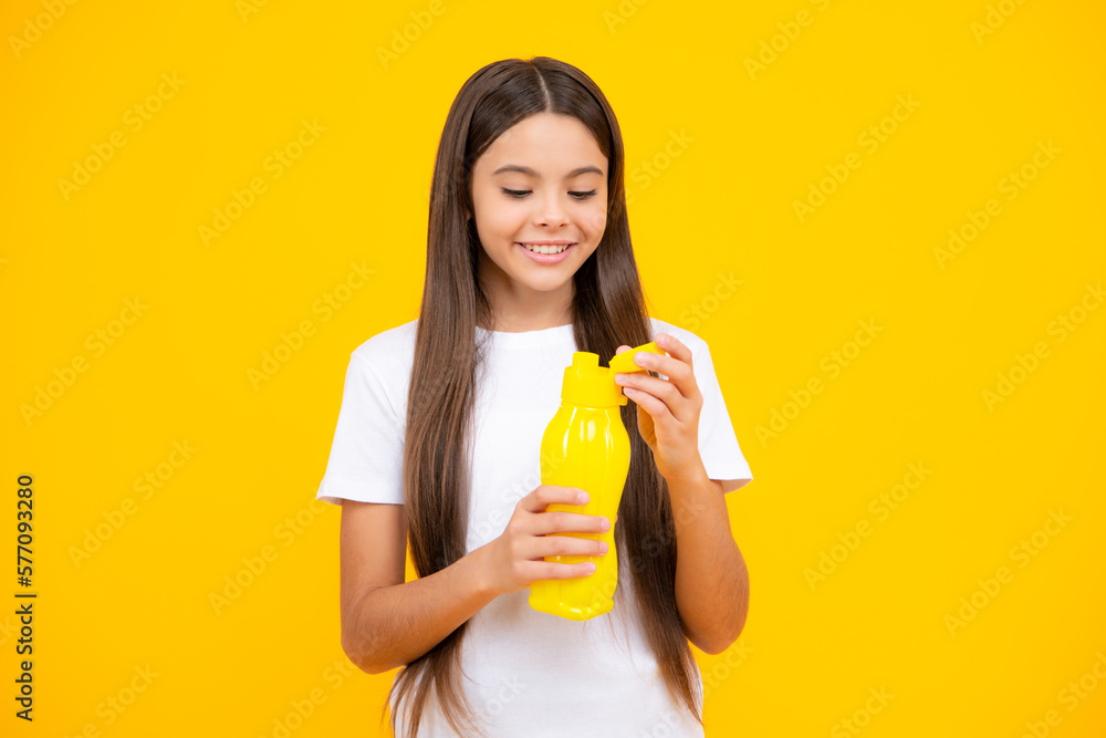 Child teen with water bottle isolated studio background. Water bottle and healthy life. Health and water balance. Happy teenager portrait. Smiling girl. Child teen with water bottle isolated studio background. Water bottle and healthy life. Health and water balance. Happy teenager portrait. Smiling girl.