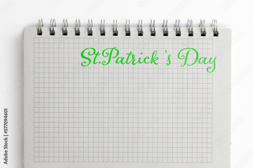 Notebook with text St Patricks Day on white background. St Patricks Day celebration concept Notebook with text St Patricks Day on white background. St Patricks Day celebration concept