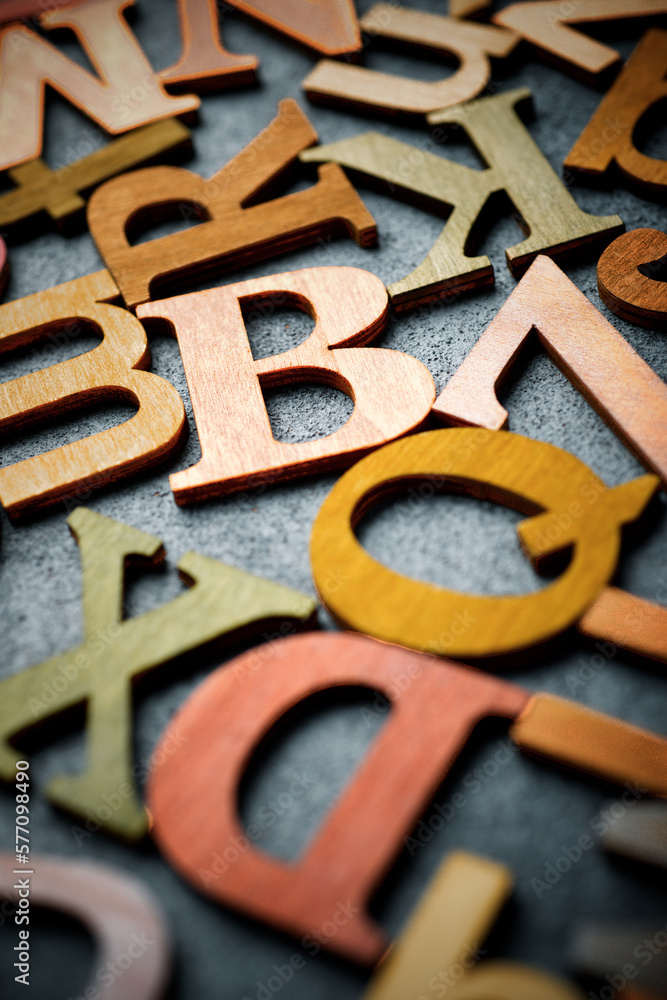 Colored wooden letters on a gray table Colored wooden letters on a gray table