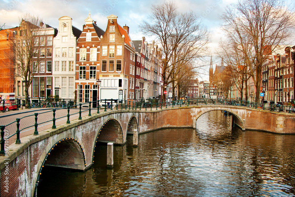 Fototapeta premium Old bridges and traditional houses along a canal in the centre of Amsterdam, the Nederlands