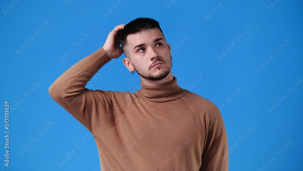 4k video of a man thinking about something over blue background. 4k video of a man thinking about something over blue background.