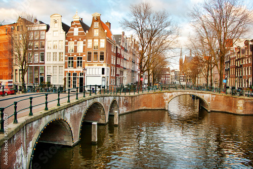 Old bridges and traditional houses along a canal in the centre of Amsterdam, the Nederlands