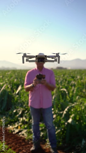 Drone as head of person. Operator behind the drone flying in a sustainable crop field. Technology concept in the agricultural industry