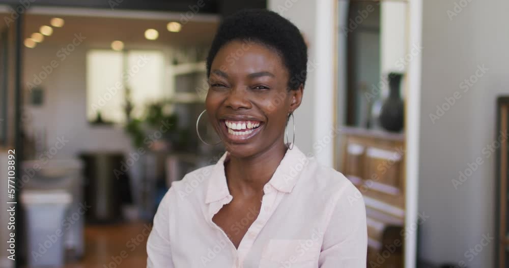 Portrait of happy african american woman looking at camera and smiling Portrait of happy african american woman looking at camera and smiling