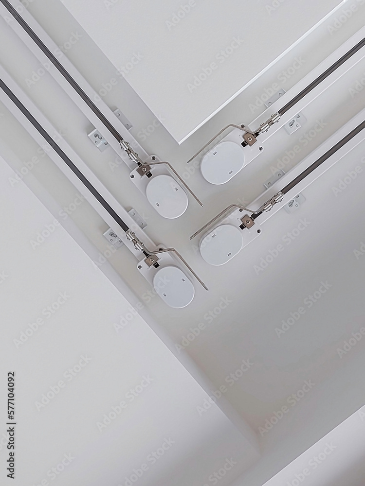 Automatic curtain rods installed on the ceiling. Bottom view. The mechanism of the motorized