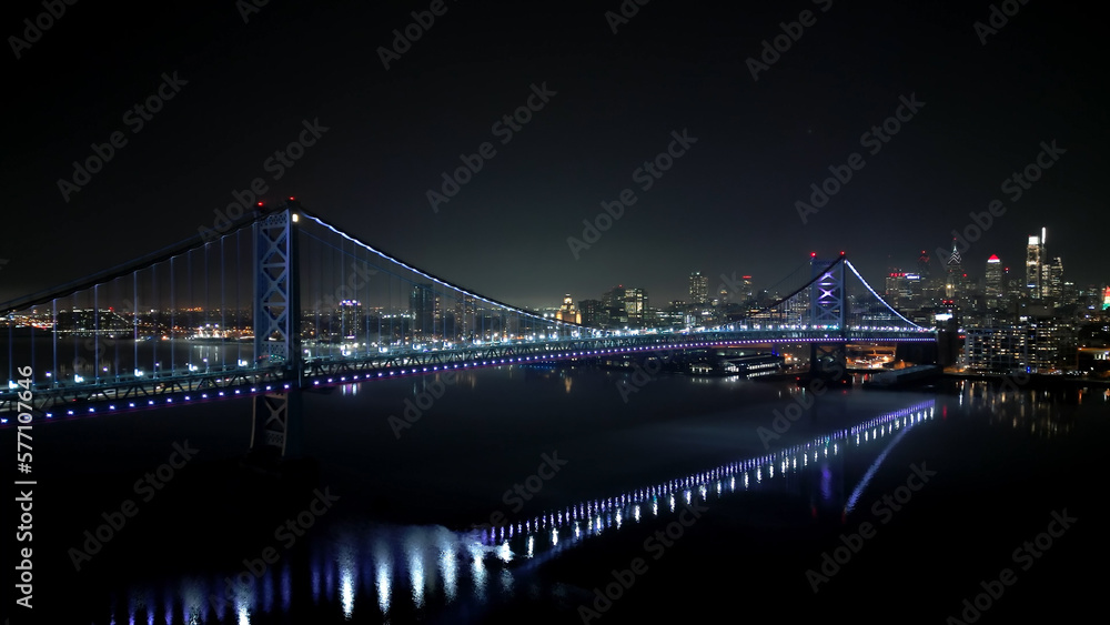 Obraz premium Benjamin Franklin Bridge and Skyline of Philadelphia at night - aerial view - drone photography