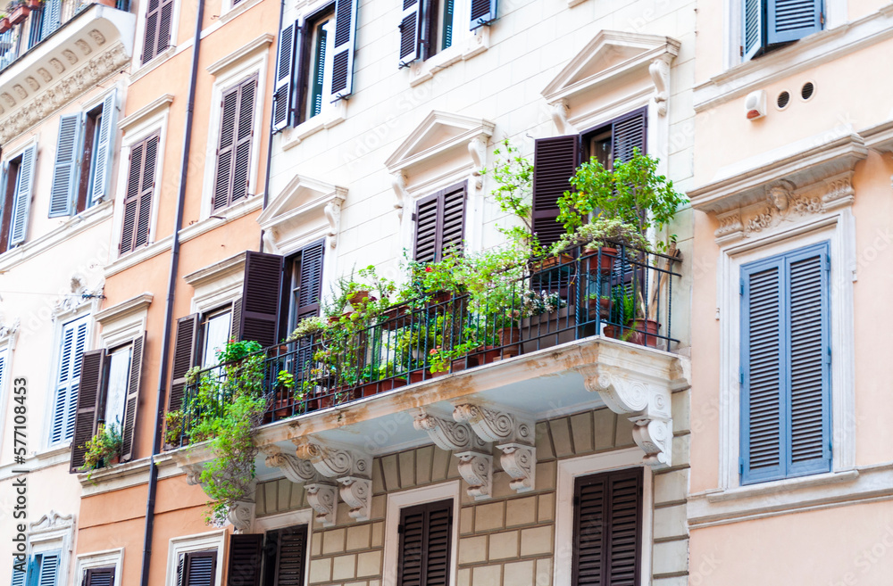 Fototapeta premium Beautiful balcony with greenery on the facade of an old building in central Rome, Italy.