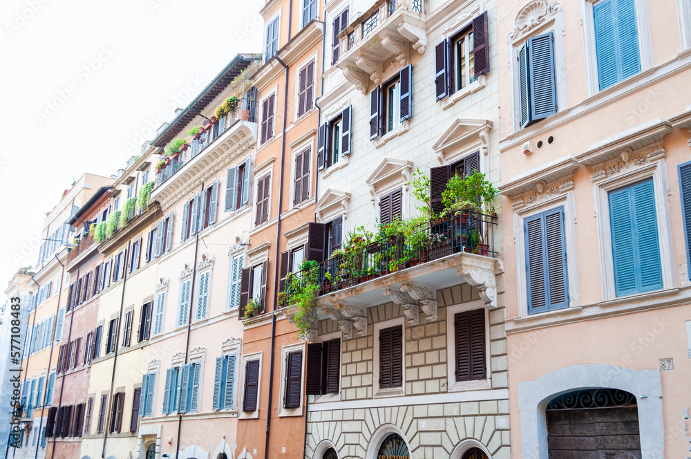 Beautiful balcony with greenery on the facade of an old building in central Rome, Italy.