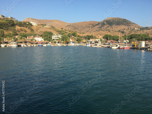 View of Kalekoy town and the lighthouse from the sea of Gokceada. Imbros island kalekoy harbor. Imbros island in Canakkale Turkey