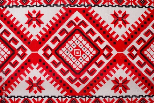 Embroidered fabric with red and black details on a white background, cubes and various mosaics as a decorative background