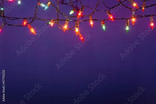 Fototapeta Naklejka Na Ścianę i Meble -  Christmas lights string on blue background with copy space