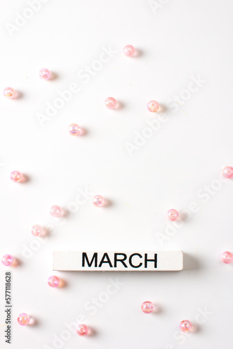 A banner with an empty space and the inscription March decorated with pink beads. The concept of International Women's Day on March 8, spring festival