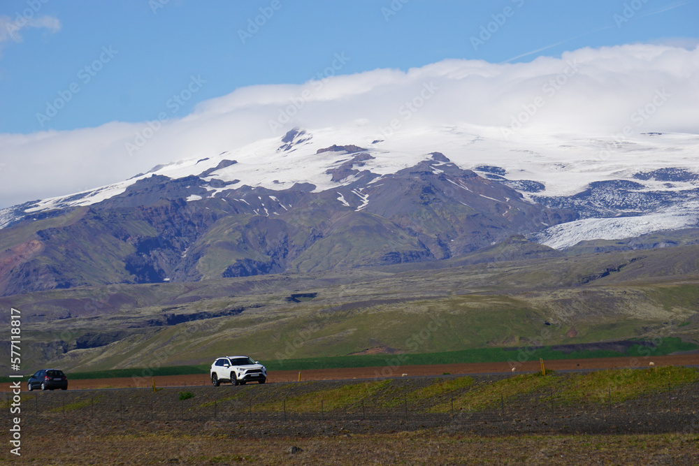 Mountains covered with snow and driving cars in Iceland