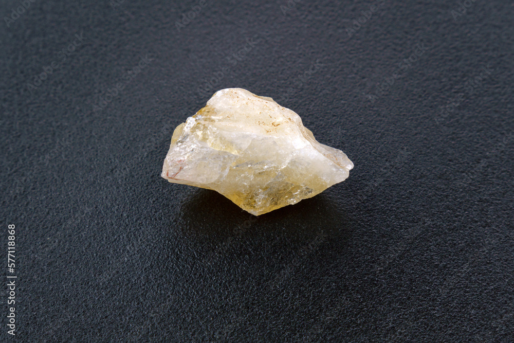 Natural stone of untreated citrine crystal, yellow quartz. Selective focus, black background