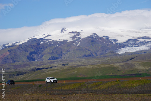 Mountains covered with snow and driving cars in Iceland