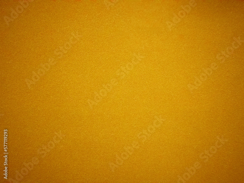 Yellow velvet fabric texture used as background. Empty yellow fabric background of soft and smooth textile material. There is space for text...