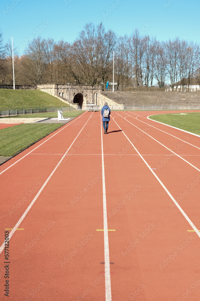 Fototapeta premium walking girl on running track in the stadium