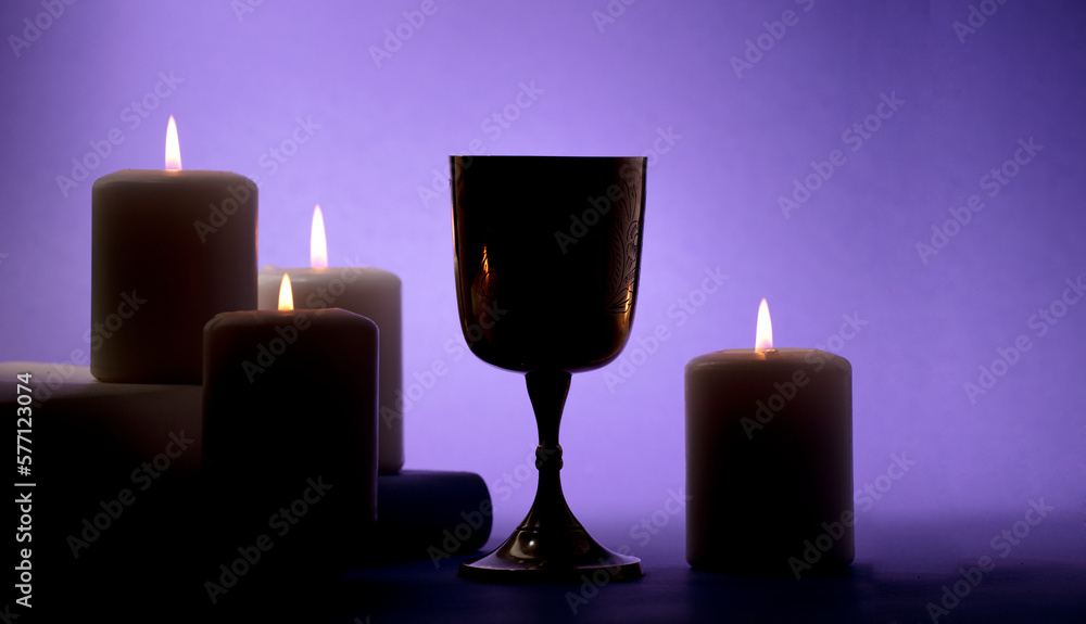 golden christian chalice silhouette with candles and flame and purple background golden christian chalice silhouette with candles and flame and purple background