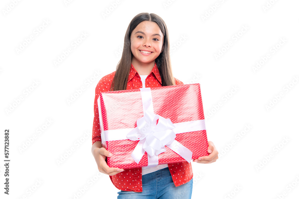 Child with gift present box on isolated studio background. Gifting for kids birthday. Portrait of happy smiling teenage girl. Child with gift present box on isolated studio background. Gifting for kids birthday. Portrait of happy smiling teenage girl.