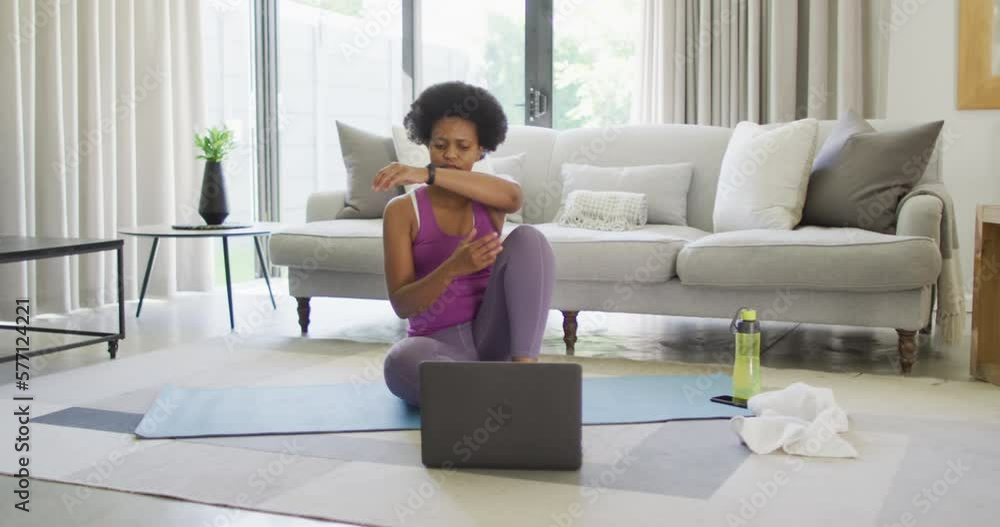 Happy african american wearing sportswear, exercising, using laptop Happy african american wearing sportswear, exercising, using laptop