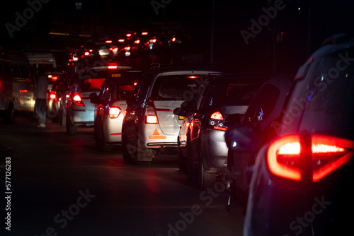 Night shot of car lights stuck for large distance in traffic jam at night on a narrow road in the Indian hill station of Manali Kullu himachal Pradesh India popular tourist destination