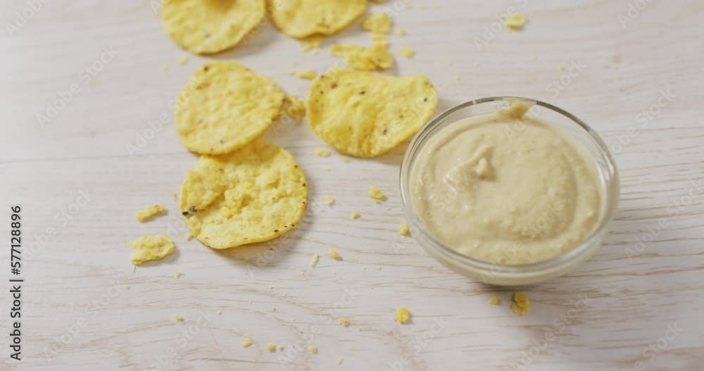 Video of crisps and cheese dip on a wooden surface Video of crisps and cheese dip on a wooden surface