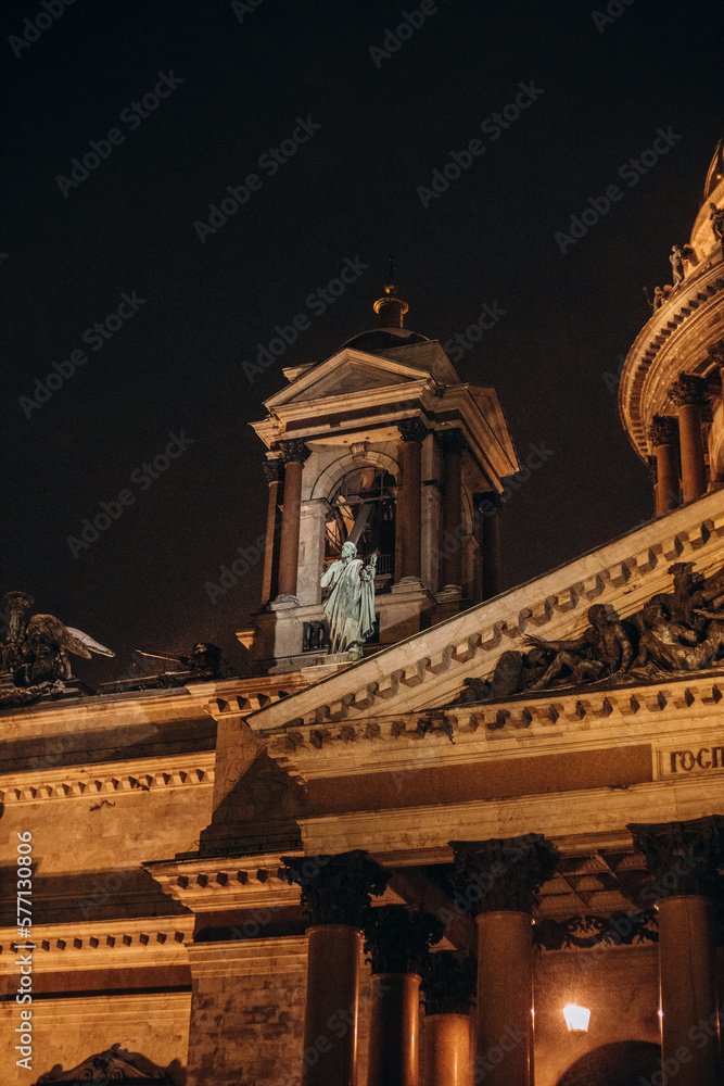 Fototapeta premium Big and majestic cathedral at night in a big city. Ancient architectural masterpiece.