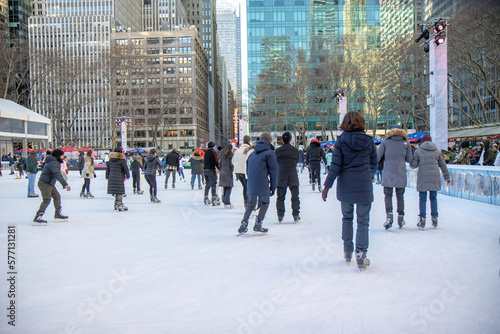 People ice skating on outdoor rink in Bryant Park, New York City, daytime