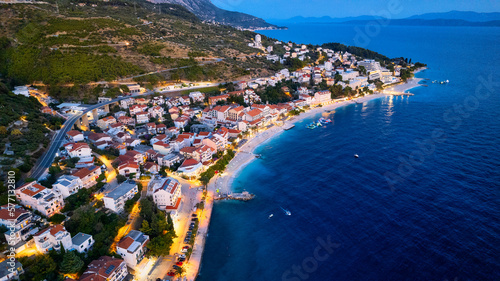 Croatia's harbor is a sight to behold from above. This breathtaking aerial view captures the colorful landscape filled with sailboats, motorboats, and luxurious yachts resting in a clear blue bay. Add