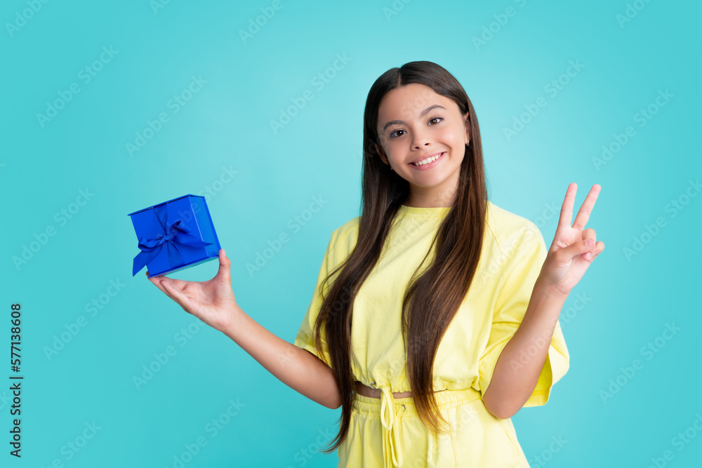 Teenager child with gift box. Present for holidays. Happy birthday, Valentines day, New Year or Christmas. Kid hold present box. Happy girl face, positive and smiling emotions. Teenager child with gift box. Present for holidays. Happy birthday, Valentines day, New Year or Christmas. Kid hold present box. Happy girl face, positive and smiling emotions.