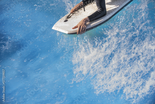Photography A surfer on a bodyboard surfing in the wave of a swimming pool