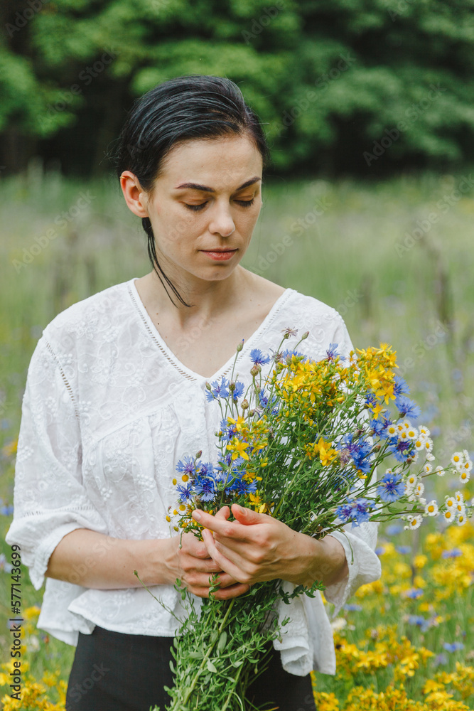 Beautiful girl among the summer field with wildflowers Beautiful girl among the summer field with wildflowers