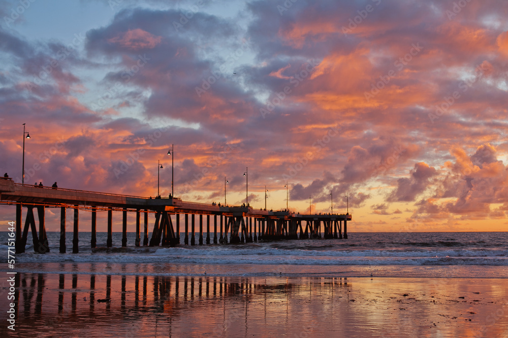 Long pier and colorful sunset sky on pacific ocean, California, USA 