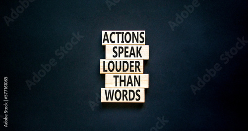 Actions speak louder words symbol. Concept words Actions speak louder than words on wooden blocks. Beautiful black table black background. Business new mindset for results concept. Copy space. photo