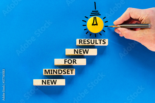 New mindset and results symbol. Concept words New mindset for new results on wooden blocks. Beautiful blue background. Businessman hand. Business new mindset for results concept. Copy space.