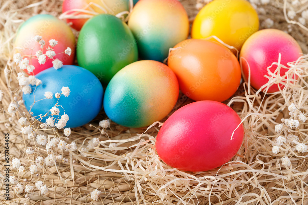 Easter painted colorful natural chicken eggs with dried hay and flowers lying on rustic background. Easter painted colorful natural chicken eggs with dried hay and flowers lying on rustic background.
