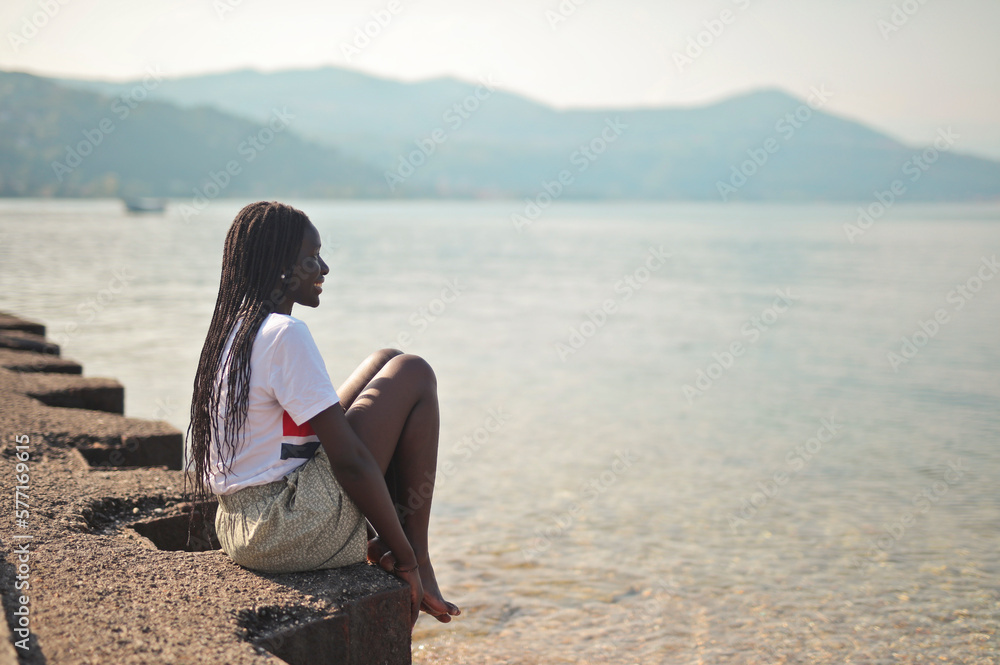 young black woman on the shore of a lake