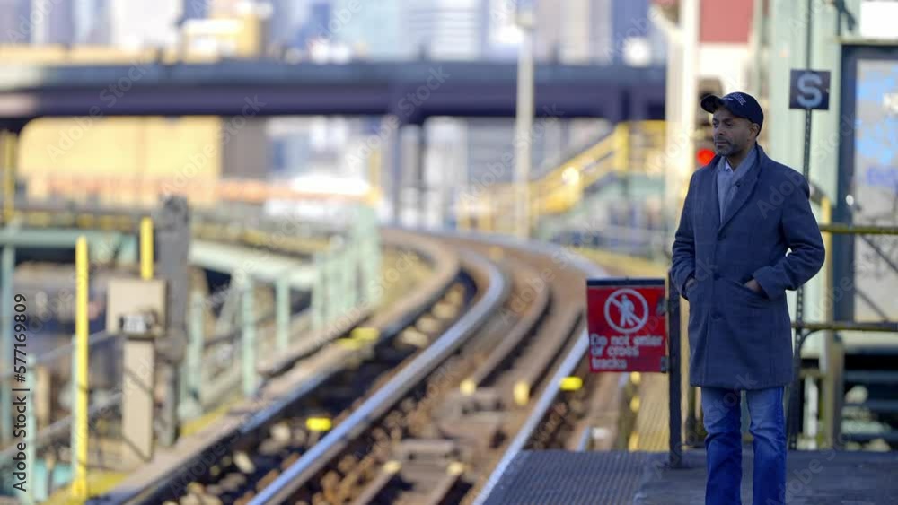 Man waiting for the subway train in New York - travel photography Man waiting for the subway train in New York - travel photography