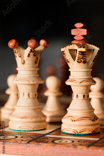 Wooden King and Queen on Chessboard