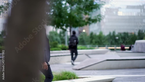 Wallpaper Mural Determined adult male in expensive suit and stylish eye glasses walking in financial district with cellular device in hands. Confident businessman heading forward between people on city street Torontodigital.ca