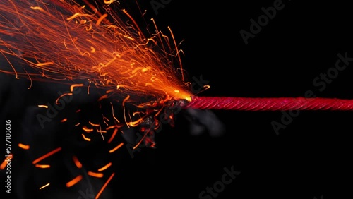 A macro shot of a burning fuse in front of a black background. photo